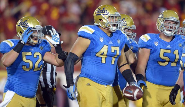 Nov 30, 2013; Los Angeles, CA, USA; UCLA Bruins defensive end Eddie Vanderdoes (47) celebrates after scoring on a 1-yard touchdown run in the second quarter against the Southern California Trojans at Los Angeles Memorial Coliseum. Mandatory Credit: Kirby Lee-USA TODAY Sports