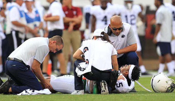 Sep 5, 2015; Philadelphia, PA, USA;  Penn State Nittany Lions linebacker Nyeem Wartman-White (5) reacts while trainers work on his leg as head coach James Franklin looks during the second quarter against the Temple Owl at Lincoln Financial Field. Mandatory Credit: Matthew O'Haren-USA TODAY Sports