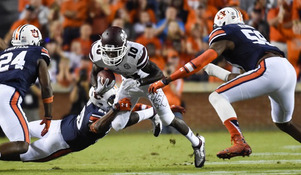 Sep 26, 2015; Auburn, AL, USA; Mississippi State Bulldogs running back Brandon Holloway (10) runs the ball while defended by Auburn Tigers defensive back Jeremiah Dinson (20) during the first quarter at Jordan Hare Stadium. Mandatory Credit: Shanna Lockwood-USA TODAY Sports