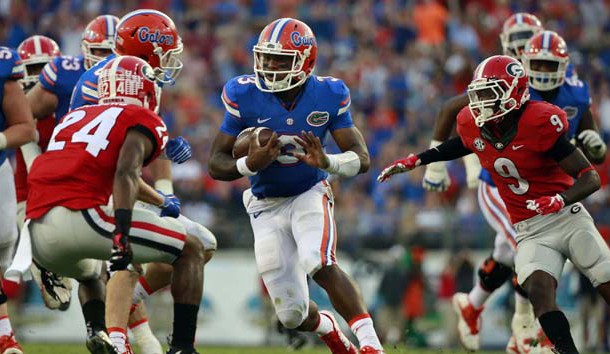 Oct 31, 2015; Jacksonville, FL, USA; Florida Gators quarterback Treon Harris (3) runs with the ball as Georgia Bulldogs safety Dominick Sanders (24) and cornerback Reggie Wilkerson (9) defends during the second half at  EverBank Stadium. Florida Gators defeated the Georgia Bulldogs 27-3. Mandatory Credit: Kim Klement-USA TODAY Sports