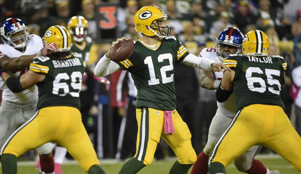 Oct 9, 2016; Green Bay, WI, USA; Green Bay Packers quarterback Aaron Rodgers (12) passes in the third quarter during the game against the New York Giants at Lambeau Field. Photo Credit: Benny Sieu-USA TODAY Sports