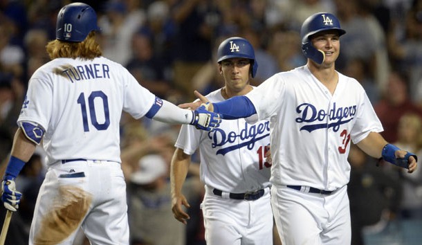 August 15, 2017; Los Angeles, CA, USA; Los Angeles Dodgers center fielder Joc Pederson (31) and catcher Austin Barnes (15) are greeted by third baseman Justin Turner (10) after both scoring runs in the eighth inning against the Chicago White Sox at Dodger Stadium. Photo Credit: Gary A. Vasquez-USA TODAY Sports