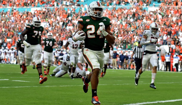 Nov 18, 2017; Miami Gardens, FL, USA; Miami Hurricanes running back Travis Homer (24) scores a touchdown during the second half against Virginia Cavaliers at Hard Rock Stadium. Photo Credit: Steve Mitchell-USA TODAY Sports