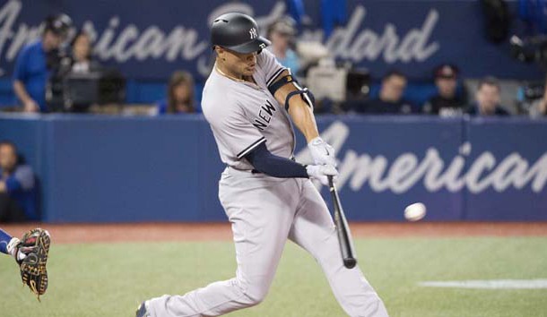 Mar 29, 2018; Toronto, Ontario, CAN; New York Yankees right fielder Giancarlo Stanton (27) hits a two run home run in the first inning during the Toronto Blue Jays home opener at Rogers Centre. Photo Credit: Nick Turchiaro-USA TODAY Sports