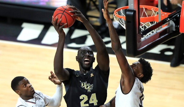 Feb 21, 2019; Cincinnati, OH, USA; UCF Knights center Tacko Fall (24) drives to the basket against Cincinnati Bearcats center Nysier Brooks (33) and forward Trevon Scott (13) in the second half at Fifth Third Arena. Photo Credit: Aaron Doster-USA TODAY Sports