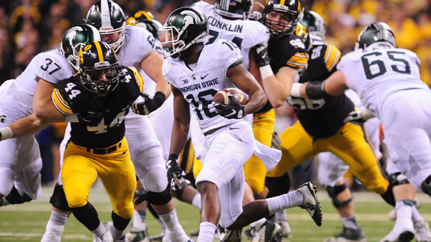 Dec 5, 2015; Indianapolis, IN, USA; Michigan State Spartans wide receiver Aaron Burbridge (16) runs the ball as Iowa Hawkeyes linebacker Ben Niemann (44) looks to defend during the first half in the Big Ten Conference football championship game at Lucas Oil Stadium. Mandatory Credit: Thomas J. Russo-USA TODAY Sports