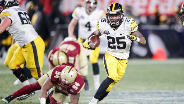 Dec 27, 2017; Bronx, NY, USA; Iowa Hawkeyes running back Akrum Wadley (25) rushes against Boston College Eagles defensive tackle Noa Merritt (94) during the second half of the 2017 Pinstripe Bowl at Yankee Stadium. Photo Credit: Vincent Carchietta-USA TODAY Sports