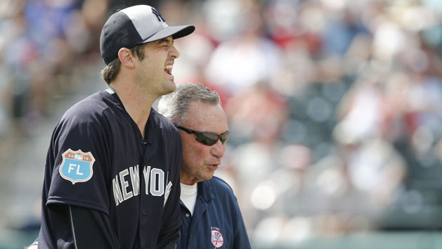 Mar 30, 2016; Lake Buena Vista, FL, USA; Trainers attend to New York Yankees relief pitcher Andrew Miller (left) after he was hit by a line drive back to the mound during the seventh inning of a spring training baseball game against the Atlanta Braves at Champion Stadium. Mandatory Credit: Reinhold Matay-USA TODAY Sports