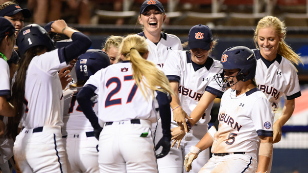 Emily Carosone (right) being greeted at home plate after the walk-off grand slam. (Photo courtesy of Auburn University.)