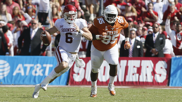 Oct 14, 2017; Dallas, TX, USA; Oklahoma Sooners quarterback Baker Mayfield (6) runs the ball against Texas Longhorns defensive lineman Poona Ford (95) in the first quarter at the Cotton Bowl. Photo Credit: Tim Heitman-USA TODAY Sports