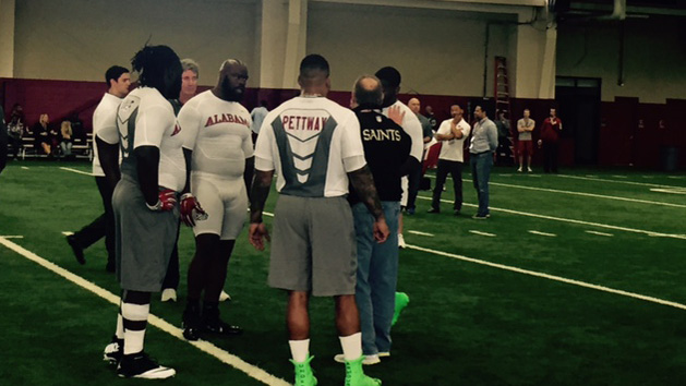 New Orleans defensive line coach Bill Johnson talks to Alabama defensive linemen Darren Lake (left), A'Shawn Robinson (facing), D.J. Pettway and Jarran Reed. (Matt Lowe)