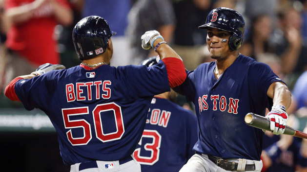 Jun 24, 2016; Arlington, TX, USA; Boston Red Sox right fielder Mookie Betts (50) celebrates his game tying two-run home run with shortstop Xander Bogaerts (right) against the Texas Rangers during the ninth inning of a baseball game at Globe Life Park in Arlington. The Red Sox won 8-7. Mandatory Credit: Jim Cowsert-USA TODAY Sports
