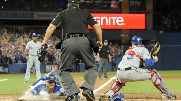 Oct 9, 2016; Toronto, Ontario, CAN; Toronto Blue Jays third baseman Josh Donaldson (20) slides in to score the winning run past Texas Rangers catcher Jonathan Lucroy (25) in the 10th inning to give the Jays a three game sweep in 2016 ALDS at Rogers Centre. Photo Credit: Dan Hamilton-USA TODAY Sports