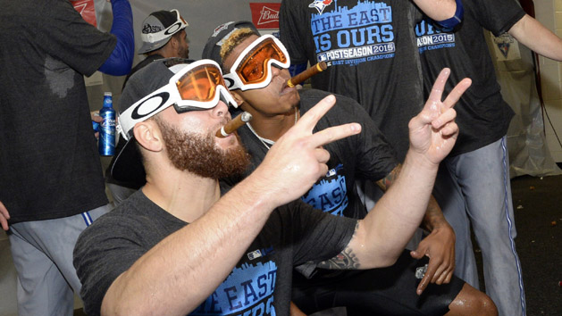 Sep 30, 2015; Baltimore, MD, USA; Toronto Blue Jays catcher Russell Martin (left) and starting pitcher Marcus Stroman (6) pose for photos as they celebrate winning the A.L. East division after game two of a double header in the visiting locker room at Oriole Park at Camden Yards. The Toronto Blue Jays clinched the division after game one of the double header. Mandatory Credit: Tommy Gilligan-USA TODAY Sports