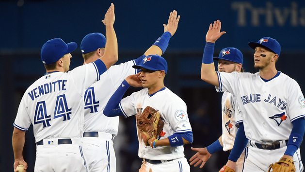 Apr 13, 2016; Toronto, Ontario, CAN; Toronto Blue Jays second baseman Ryan Goins (17) and shortstop Troy Tulowitzki (2) celebrate with teammates after beating New York Yankees 7-2 at Rogers Centre. Mandatory Credit: Dan Hamilton-USA TODAY Sports