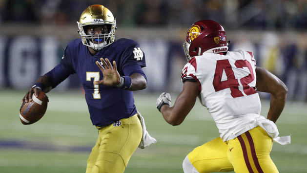 Oct 21, 2017; South Bend, IN, USA; Notre Dame Fighting Irish quarterback Brandon Wimbush (7) scrambles out of the pocket against Southern California Trojans linebacker Uchenna Nwosu (42) at Notre Dame Stadium. Photo Credit: Brian Spurlock-USA TODAY Sports