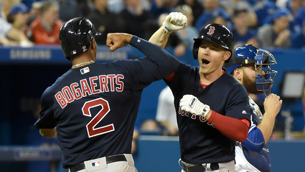 Apr 8, 2016; Toronto, Ontario, CAN; Boston Red Sox left fielder Brock Holt (12) is greeted at home plate by shortstop Xander Bogaerts (2) after hitting a grand slam home run against Toronto Blue Jays in the fifth inning at Rogers Centre. Mandatory Credit: Dan Hamilton-USA TODAY Sports