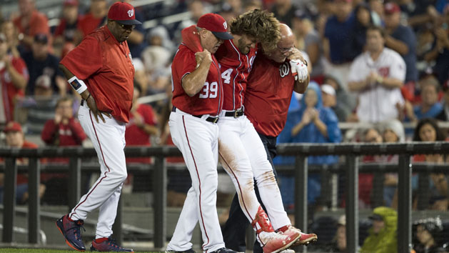 Aug 12, 2017; Washington, DC, USA; Washington Nationals right fielder Bryce Harper (34) gets helped off the field by hitting coach Rick Schu (39) and trainer Paul Lessard after suffering an apparent injury against the San Francisco Giants during the first inning at Nationals Park. Photo Credit: Michael Owens-USA TODAY Sports