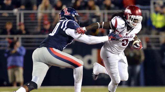 Nov 7, 2015; Oxford, MS, USA;Arkansas Razorbacks running back Alex Collins (3) is defended by Mississippi Rebels linebacker C.J. Johnson (10) during the fourth quarter of the game at Vaught-Hemingway Stadium. Arkansas won 53-52. Mandatory Credit: Matt Bush-USA TODAY Sports