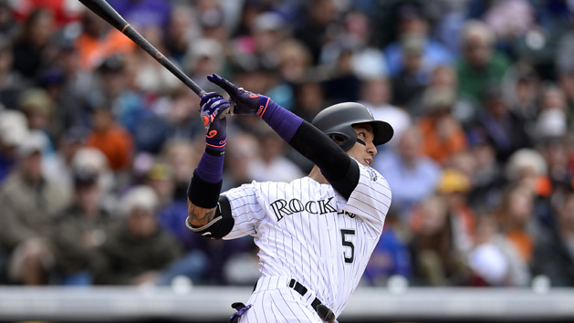 May 15, 2016; Denver, CO, USA; Colorado Rockies right fielder Carlos Gonzalez (5) hits a solo home run in the seventh inning against the New York Mets at Coors Field. Mandatory Credit: Ron Chenoy-USA TODAY Sports