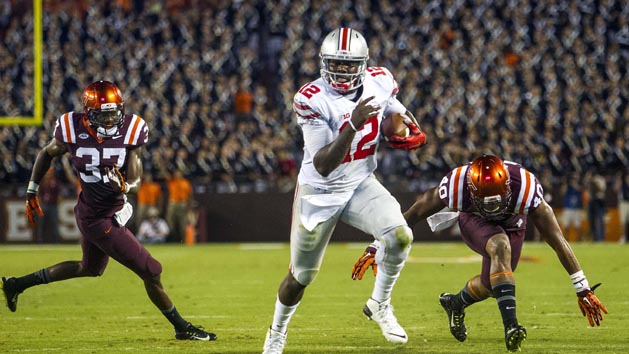 Sep 7, 2015; Blacksburg, VA, USA; Ohio State Buckeyes quarterback Cardale Jones (12) rushes the ball against Virginia Tech Hokies linebacker Ronny Vandyke (37) and linebacker Deon Clarke (40) at Lane Stadium. Mandatory Credit: Peter Casey-USA TODAY Sports
