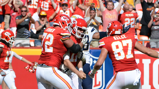 Sep 11, 2016; Kansas City, MO, USA; Kansas City Chiefs quarterback Alex Smith (11) is congratulated after scoring the winning touchdown in overtime against the San Diego Chargers at Arrowhead Stadium. Kansas City won 33-27. John Credit: John Rieger-USA TODAY Sports