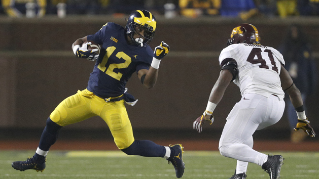 Nov 4, 2017; Ann Arbor, MI, USA; Michigan Wolverines running back Chris Evans (12) runs the ball against Minnesota Golden Gophers linebacker Thomas Barber (41) during the fourth quarter at Michigan Stadium. Photo Credit: Raj Mehta-USA TODAY Sports