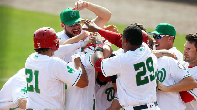 Mar 17, 2016; Melbourne, FL, USA; Washington Nationals center fielder Chris Heisey (14) celebrates with his teammates after hitting the game winning home run against the Atlanta Braves in the ninth inning at Space Coast Stadium. The Washington Nationals won 9-7. Mandatory Credit: Logan Bowles-USA TODAY Sports