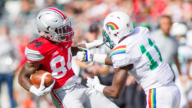 Sep 12, 2015; Columbus, OH, USA; Ohio State Buckeyes wide receiver Corey Smith (84) avoids a tackle during the game against the Hawaii Warriors at Ohio Stadium. The Ohio State Buckeyes beat the Hawaii Warriors by the score of 38-0. Mandatory Credit: Trevor Ruszkowski-USA TODAY Sports