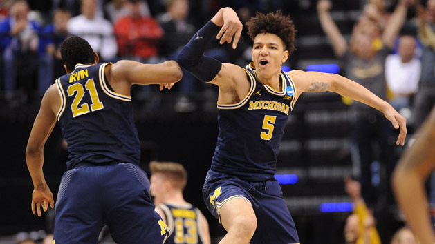 Mar 19, 2017; Indianapolis, IN, USA; Michigan Wolverines guard Zak Irvin (21) celebrates with forward D.J. Wilson (5) after defeating the Louisville Cardinals in the second round of the 2017 NCAA Tournament at Bankers Life Fieldhouse. Photo Credit: Thomas Joseph-USA TODAY Sports