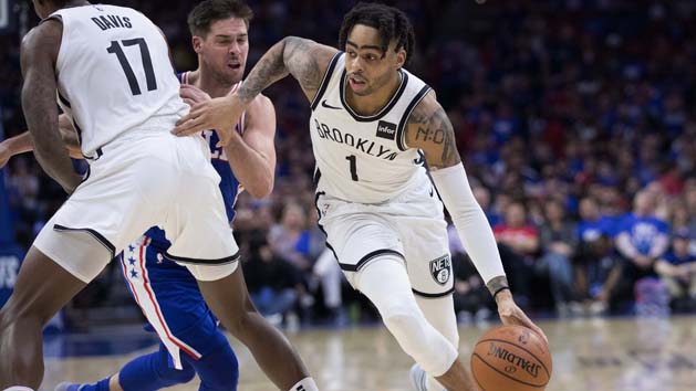 Apr 13, 2019; Philadelphia, PA, USA; Brooklyn Nets guard D'Angelo Russell (1) dribbles past Philadelphia 76ers guard T.J. McConnell (12) during the fourth quarter in game one of the first round of the 2019 NBA Playoffs at Wells Fargo Center. Photo Credit: Bill Streicher-USA TODAY Sports