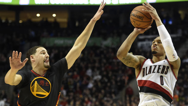 Feb 19, 2016; Portland, OR, USA; Portland Trail Blazers guard Damian Lillard (0) hits a three point shot over Golden State Warriors guard Klay Thompson (11) during the third quarter of the game at the Moda Center at the Rose Quarter. Lillard scored 51 points as the Blazers won 137-105. Mandatory Credit: Steve Dykes-USA TODAY Sports