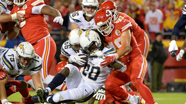 Dec 16, 2017; Kansas City, MO, USA; Los Angeles Chargers running back Melvin Gordon (28) runs the ball and is tackled by Kansas City Chiefs strong safety Daniel Sorensen (49) during the first half at Arrowhead Stadium. Mandatory Credit: Denny Medley-USA TODAY Sports