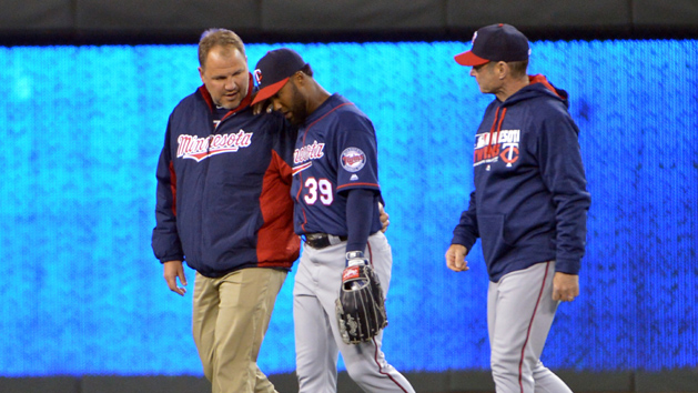 Apr 9, 2016; Kansas City, MO, USA; Minnesota Twins center fielder Danny Santana (39) is assisted off the field by manager Paul Molitor (4) and medical personnel after an injury in the sixth inning against the Kansas City Royals at Kauffman Stadium. Mandatory Credit: Denny Medley-USA TODAY Sports