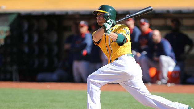 Danny Valencia (26) hits an RBI single against the Houston Astros during the ninth inning for a walk-off win at O.co Coliseum. The Athletics won 5-4. (Kelley L Cox-USA TODAY Sports)