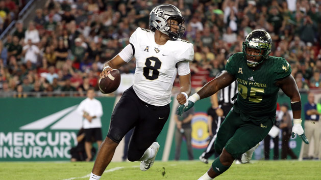 Nov 23, 2018; Tampa, FL, USA; UCF Knights quarterback Darriel Mack Jr. (8) runs out of the pocket as South Florida Bulls defensive tackle Brandon Boyce (95) pressures during the second half at Raymond James Stadium. Photo Credit: Kim Klement-USA TODAY Sports