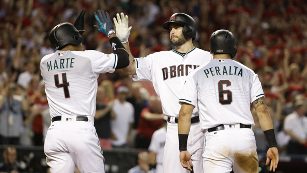 Oct 4, 2017; Phoenix, AZ, USA; Arizona Diamondbacks first baseman Paul Goldschmidt (middle) reacts after hitting a three-run home run to drive in shortstop Ketel Marte (4) and outfielder David Peralta (6) against the Colorado Rockies in the first inning of the 2017 National League wildcard playoff baseball game at Chase Field. Photo Credit: Rob Schumacher/The Arizona Republic via USA TODAY NETWORK
