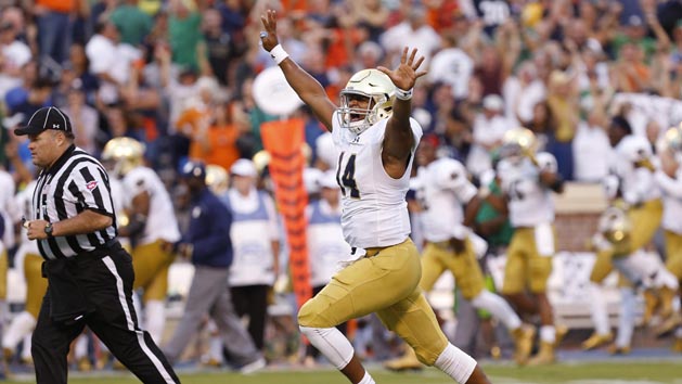 Sep 12, 2015; Charlottesville, VA, USA; Notre Dame Fighting Irish quarterback DeShone Kizer (14) celebrates after throwing the game-winning touchdown pass against the Virginia Cavaliers with twelve seconds left in the fourth quarter at Scott Stadium. The Fighting Irish won 34-27. Mandatory Credit: Geoff Burke-USA TODAY Sports