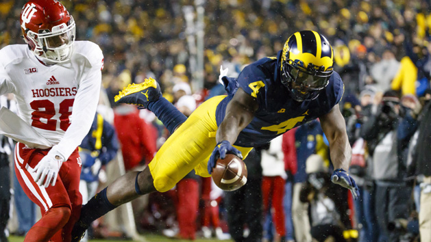 Nov 19, 2016; Ann Arbor, MI, USA; Michigan Wolverines running back De'Veon Smith (4) dives into the end zone for a touchdown in the second half defended by Indiana Hoosiers defensive back A'Shon Riggins (28) at Michigan Stadium. Michigan won 20-10. Photo Credit: Rick Osentoski-USA TODAY Sports