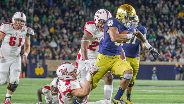 Sep 30, 2017; South Bend, IN, USA; Notre Dame Fighting Irish running back Deon McIntosh (38) runs out of the tackle of Miami (Oh) Redhawks defensive back Matt Merimee (22) in the second half of the game at Notre Dame Stadium. Photo Credit: Trevor Ruszkowski-USA TODAY Sports