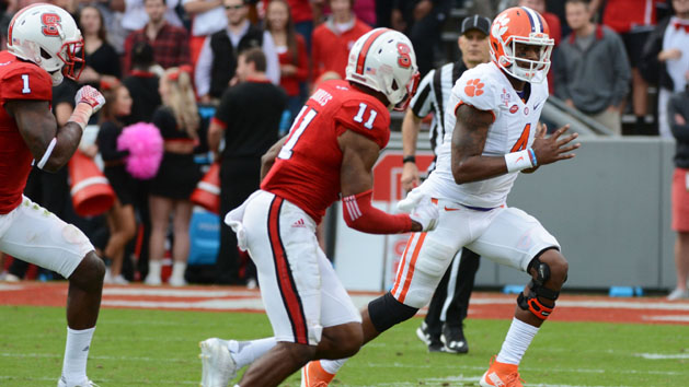 Oct 31, 2015; Raleigh, NC, USA; Clemson Tigers quarterback Deshaun Watson (4) runs during the first half as North Carolina State Wolfpack cornerback Justin Burris (11) pursues at Carter Finley Stadium. Mandatory Credit: Rob Kinnan-USA TODAY Sports
