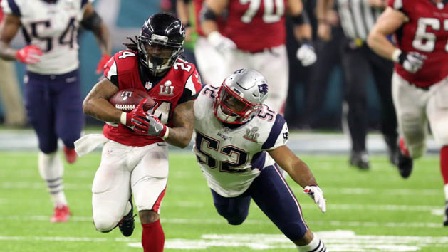Feb 5, 2017; Houston, TX, USA; Atlanta Falcons running back Devonta Freeman (24) carries the ball past New England Patriots outside linebacker Elandon Roberts (52) in the fourth quarter during Super Bowl LI at NRG Stadium. Mandatory Credit: Eric Seals-USA TODAY Sports