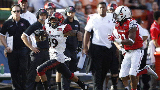 Dec 24, 2015; Honolulu, HI, USA; San Diego State Aztecs running back Donnel Pumphrey (19) makes a run down the sideline while being chased by Cincinnati Bearcats corner back Linden Stephens (32) during the second quarter in the 2015 Hawaii Bowl at Aloha Stadium. Mandatory Credit: Marco Garcia-USA TODAY Sports