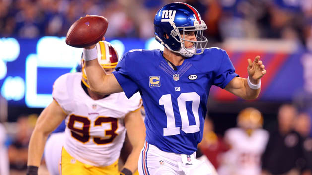 Sep 24, 2015; East Rutherford, NJ, USA; New York Giants quarterback Eli Manning (10) scrambles away from Washington Redskins linebacker Trent Murphy (93) during the second quarter at MetLife Stadium. Mandatory Credit: Brad Penner-USA TODAY Sports