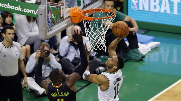 Apr 22, 2016; Boston, MA, USA; Boston Celtics guard Evan Turner (11) shoots against Atlanta Hawks forward Paul Millsap (4) during the fourth quarter in game three of the first round of the NBA Playoffs at TD Garden. Mandatory Credit: David Butler II-USA TODAY Sports