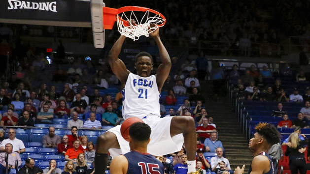 Mar 15, 2016; Dayton, OH, USA; Florida Gulf Coast Eagles forward Demetris Morant (21) dunks past Fairleigh Dickinson Knights forward Mike Holloway (34) during the first half of First Four of the NCAA men's college basketball tournament at Dayton Arena. Mandatory Credit: Rick Osentoski-USA TODAY Sports