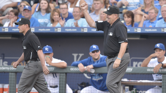 Aug 15, 2015; Kansas City, MO, USA; Umpire crew chief Gary Cederstrom (38) signals the out after a review in the first inning of the game between the Kansas City Royals and Los Angeles Angels at Kauffman Stadium. Mandatory Credit: Denny Medley-USA TODAY Sports