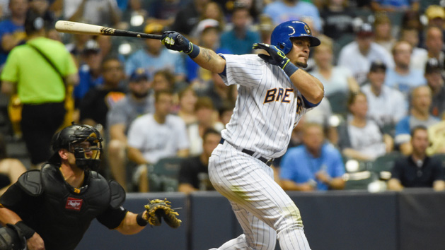 Jul 17, 2015; Milwaukee, WI, USA; Milwaukee Brewers left fielder Gerardo Parra (28) drives in a run with a double as Pittsburgh Pirates catcher Francisco Cervelli (29) watches in the fifth inning at Miller Park. Mandatory Credit: Benny Sieu-USA TODAY Sports