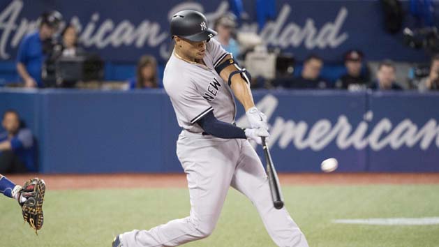 Mar 29, 2018; Toronto, Ontario, CAN; New York Yankees right fielder Giancarlo Stanton (27) hits a two run home run in the first inning during the Toronto Blue Jays home opener at Rogers Centre. Photo Credit: Nick Turchiaro-USA TODAY Sports