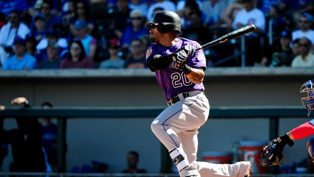Mar 11, 2017; Mesa, AZ, USA; Colorado Rockies first baseman Ian Desmond (20) singles in the first inning against the Chicago Cubs during a spring training game at Sloan Park. Photo Credit: Matt Kartozian-USA TODAY Sports